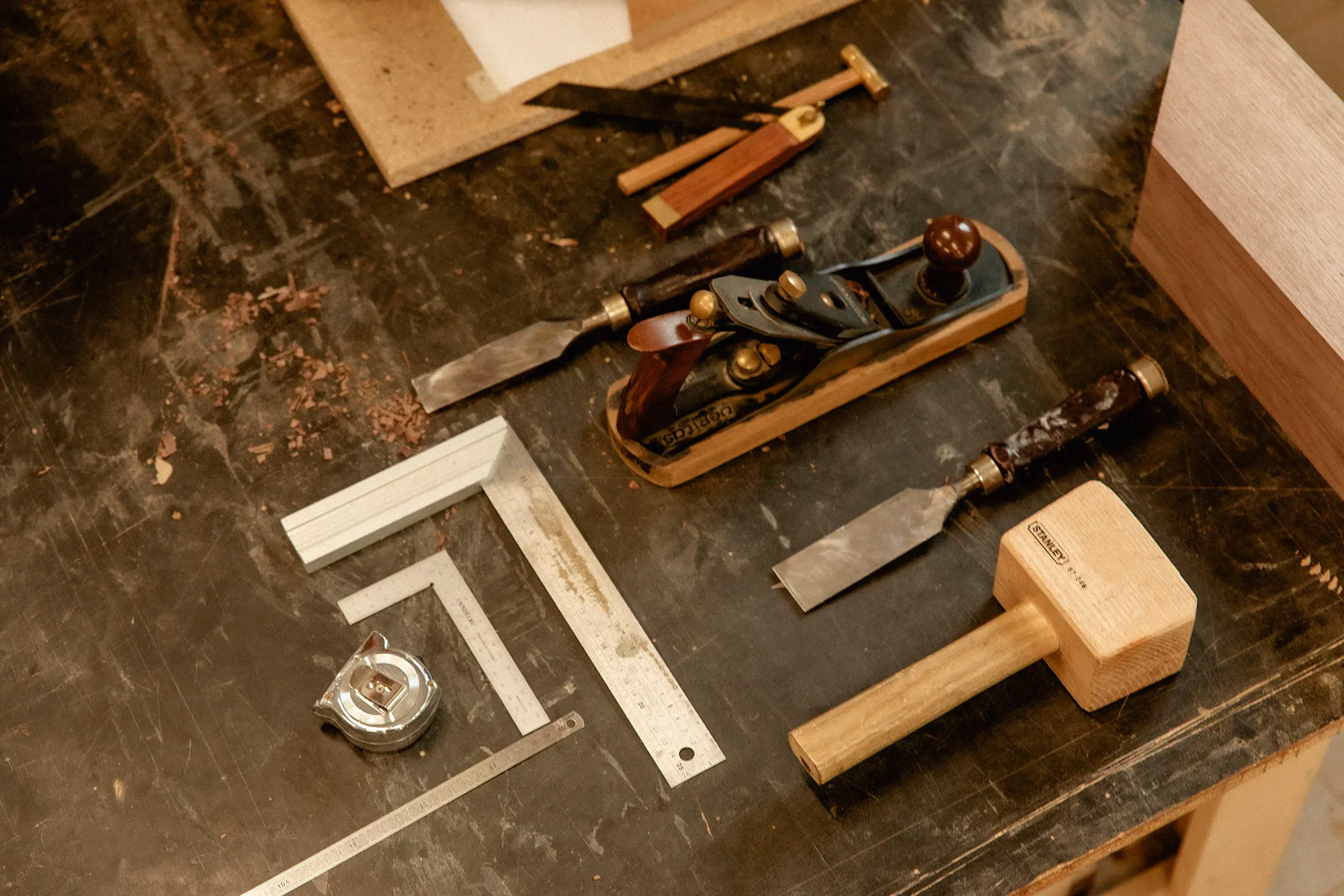 Outils de l’ébéniste sur l’établi : rabot, ciseaux à bois, équerres